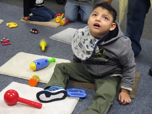 A child is experiencing the sound station at the Christmas Party